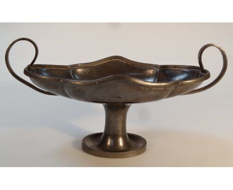 An Old English Knighthood Art Nouveau pewter dish, the shaped bowl with 'C' scroll handles on a hammered stem terminating in 