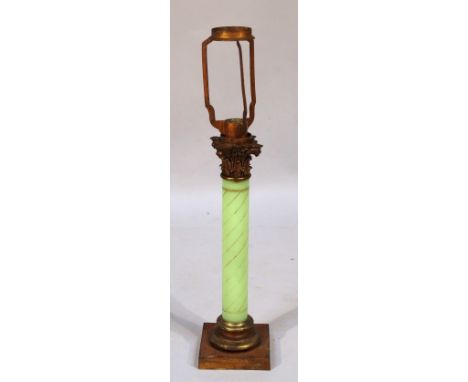 An early 20thC table lamp, of corinthian column form, with an upper gilt highlighted cylindrical glass stem on a square foot 