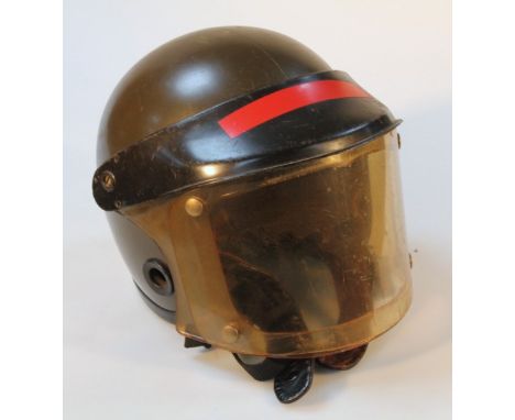 A British post war riot helmet, with visor