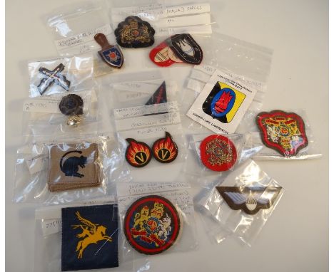 A quantity of cloth and Regimental badges, to include British Marine Commando badge, British Parachute Regiment badge, Britis