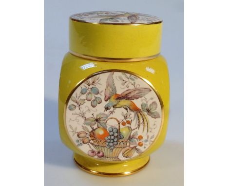 A Carltonware jar, of circular form, the yellow gilt highlighted ground broken by panels of birds and flowers on a circular f