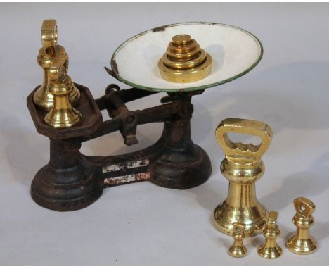 A set of brass weights, of graduated dumbbell form, to include 4lb, 16cm high, some stamped GR, further set of weights and a 