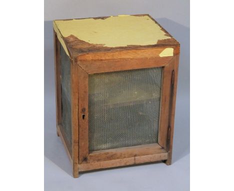 A 19thC pine meat safe, of rectangular form with mesh sides and door, revealing an interior shelf, 55cm high, 42cm wide, 38cm