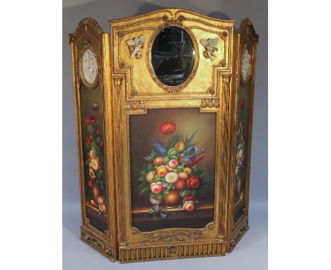 A highly elaborate gilt wood and painted three fold screen, the central section raised with moulded bell flowers and flower h