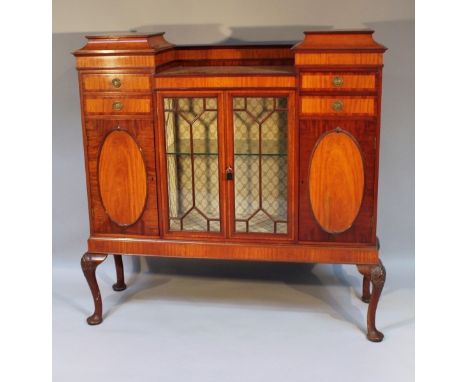 An Edwardian mahogany display cabinet, the central astragal glazed doors revealing a glass shelf, flanked by further drawers 