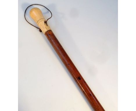 An early 20thC walking stick, of turned cylindrical form with ivory knop and (later) rubber end, 89cm high.