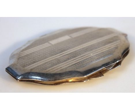A George V silver powder compact, by R Davis & Co, of shaped oval form, the engine turned lid hinging to reveal a plain mirro