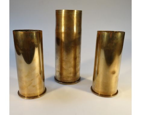 Three brass ordnance shell cases.