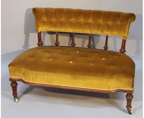 An Edwardian mahogany nursing settee, of good proportion, the scroll back raised on baluster pillars with a shaped 'D' end se