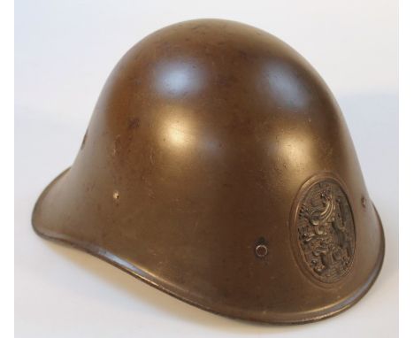 A Dutch steel infantry helmet, with lion insignia.