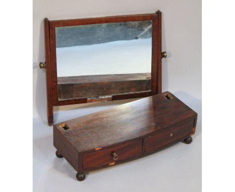 A 19thC mahogany bow fronted table mirror, the rectangular glass flanked by square supports on a platform base, set with two 