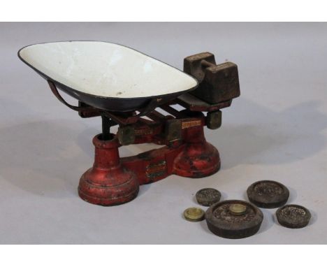 A set of early 20thC table scales, of metal form with removable tray and a quantity of various weights, 22cm high. (a quantit
