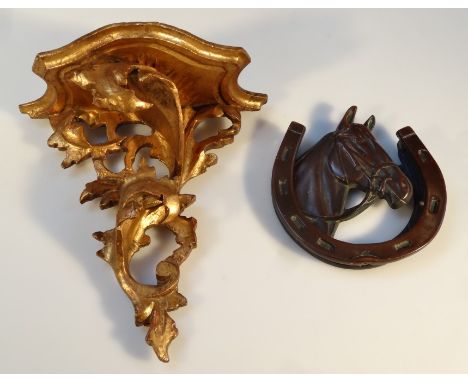 An early 20thC bronze horse head and shoe door knocker, of typical form, 14cm high, and a gilt wood rococo design hanging she