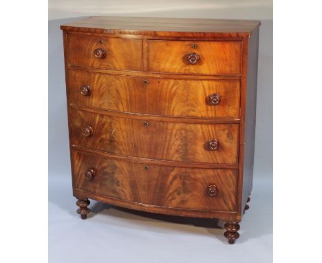 A Victorian mahogany bow front chest, of two short and three long cock beaded drawers, raised on double bun feet, 116cm high,