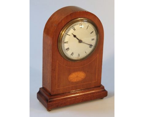 An Edwardian mahogany mantel clock, the domed case set with a circular Roman numeric bevel dial, with a key wind movement on 