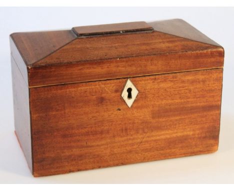 A George III mahogany tea caddy, of rectangular sarcophagus form, the hinged lid revealing a plain interior with exterior bon
