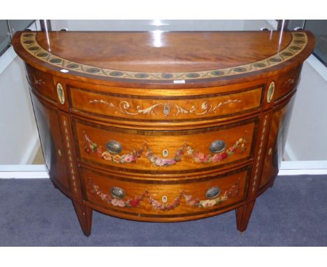 A satinwood and polychrome decorated demi-lune commode, in the manner of Seddon Sons & Shackleton, the top decorated with a p