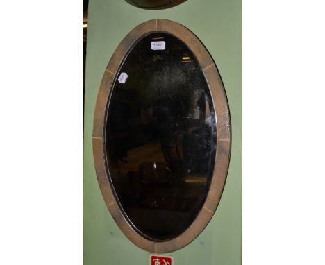 An Art Deco oval shagreen wall mirror, with bevelled edge plate glass, 40cm by 65cm CONDITION REPORT: 
