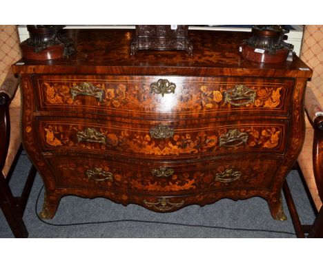 A Dutch mahogany and floral marquetry bomb‚ shaped commode, richly inlaid with flowers and insects, with three deep drawers a