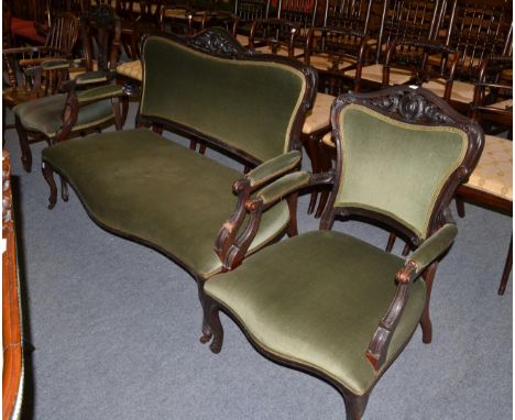 A late Victorian sofa upholstered in green velvet, 140cm wide x 59cm deep x 94cm high; with matching armchair; and salon chai