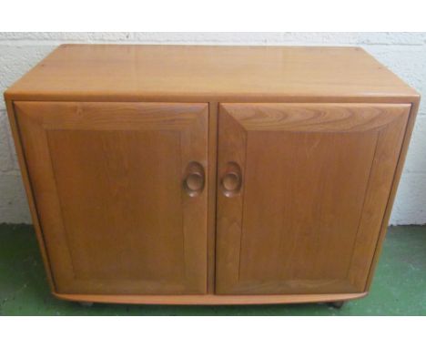 An Ercol Golden Dawn small sideboard two cupboard doors