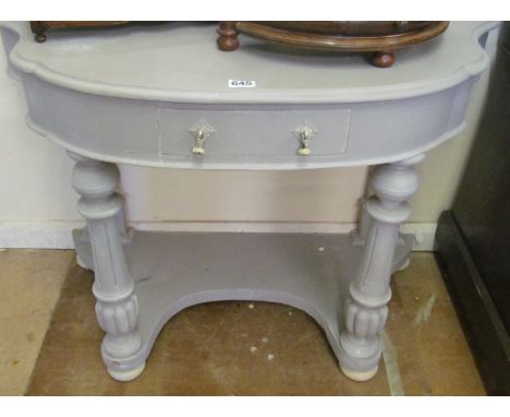 A grey demi-lune console table