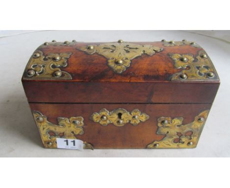 A Victorian walnut dome top tea caddy with brass mounts