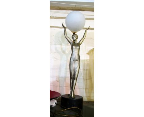 An Art Deco style lamp of a lady with ball light