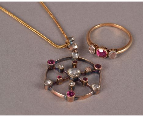 A pretty antique ruby and diamond ring and pendant set, the ring having a central round cut red stone flanked by a rose cut t