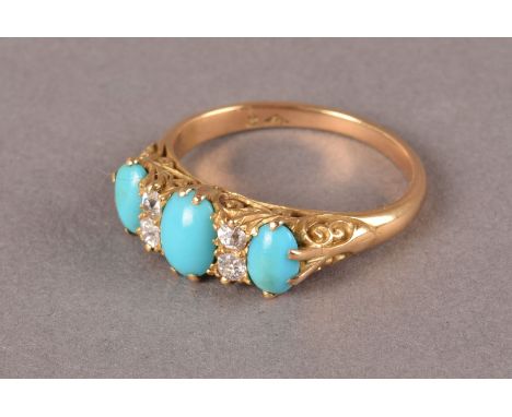 A vintage yellow metal and turquoise dress ring, the pierced scroll gallery set with three oval light green stones and four o