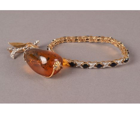 A retro amber brooch, modelled as a pear on branch, repaired, together with a gilt metal diamond and sapphire bracelet in a G