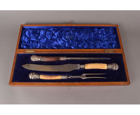 A late Victorian or Edwardian silver mounted and antler handled carving set, the fork, knife and steel in a fitted Crichton &