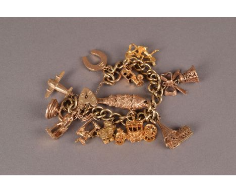 A 9ct gold and yellow metal charm bracelet, the curb link chain supporting multiple charms including a fish, carriage, vintag