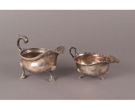 An Edwardian silver sauce boat by C S Harris & Sons Ltd., London 1909, with gadrooned edge, plus a slightly later example in 