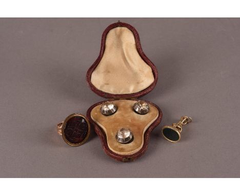 A set of three 19th century paste set dress studs, in a fitted case, together with a yellow metal and bloodstone fob seal and