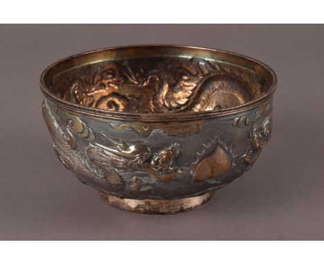 A fine vintage Chinese silver bowl, having raised design of two dragons amongst clouds, marked WH and 90 with three character