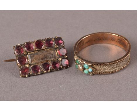 Two antique mourning jewellery items, including a garnet set brooch with glazed hair panel and a posy ring with band of plait
