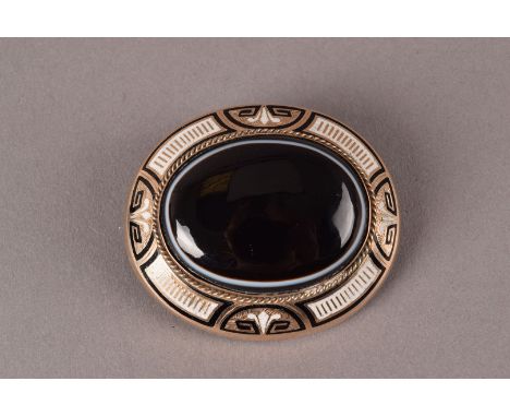 A large Victorian mourning brooch, the yellow metal oval mount set with a panel of hardstone and balck and white enamel, some