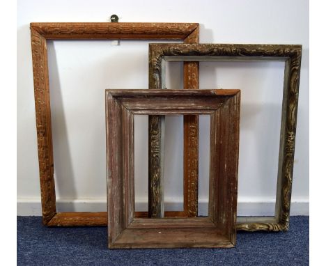 A group of three vintage pine frames, one carved with repeating flower head design, another carved in the Louis XVI taste and
