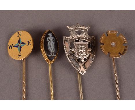 A group of four Victorian and later stick pins, including a 15ct gold example set with a rose cut stone, an enamel compass ex