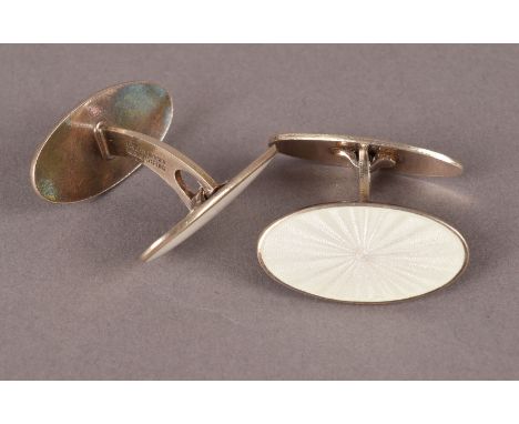 A pair of Norweigian silver and enamel cufflinks by David Andersen, having large white engine turned oval panels, marked to s