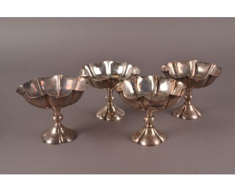 A set of four Edward VII silver dessert bowls by Henry Wilkinson & Co, having shaped bowls on quatrefoil spreading bases, mar
