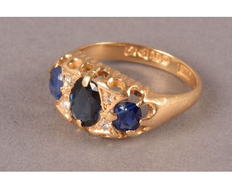 A vintage 18ct gold and gem set dress ring, having three oval sapphires, possibly synthetic and central stone replace, also h