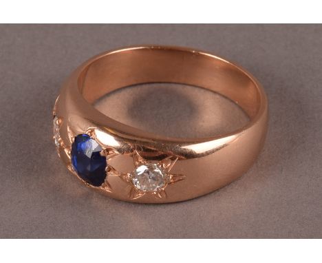 A vintage gold sapphire and diamond three stone gentleman’s signet ring the gypsy set oval blue stone flanked by a pair of br