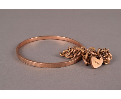 A Victorian 9ct gold bracelet and bangle, curb link chain with texturing united by a heart shaped padlock clasp and the bangl