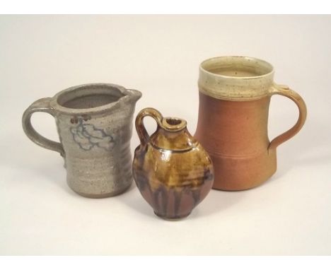 WINCHCOMBE ETC.
A Winchcombe Pottery tankard, a Mulcheney Pottery small flask & a Truro Pottery jug.  All marked. 