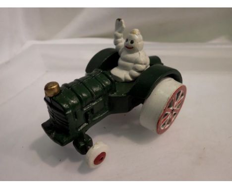Cast iron Michelin Man on a tractor, H: 80 mm. UK P&amp;P Group 1 (£16+VAT for the first lot and £2+VAT for subsequent lots) 