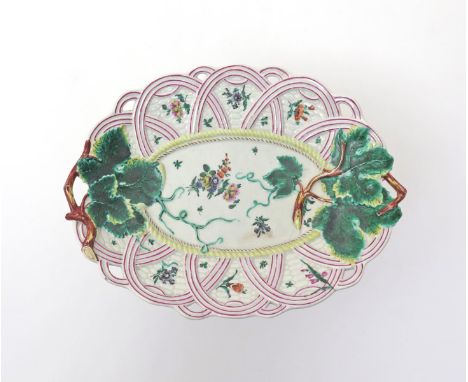 A Worcester basket moulded dish  c.1760, the handles moulded as vine stalks, the whole painted with scattered flower sprigs, 