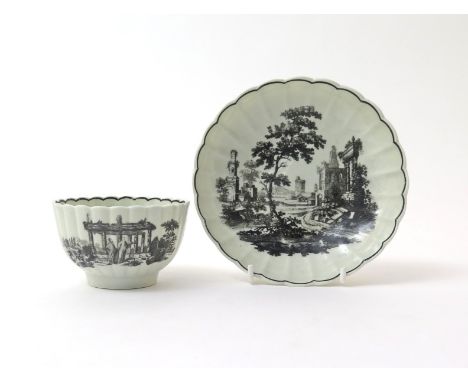 A Worcester teabowl and saucer  c.1775-70, the fluted forms printed in black with various scenes of Classical ruins, 14cm. (2