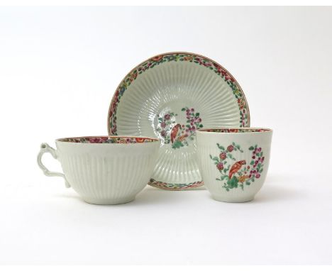 A Worcester matched trio   c.1765-68, comprising a teacup, a coffee cup and a saucer, all moulded with a continuous chrysanth